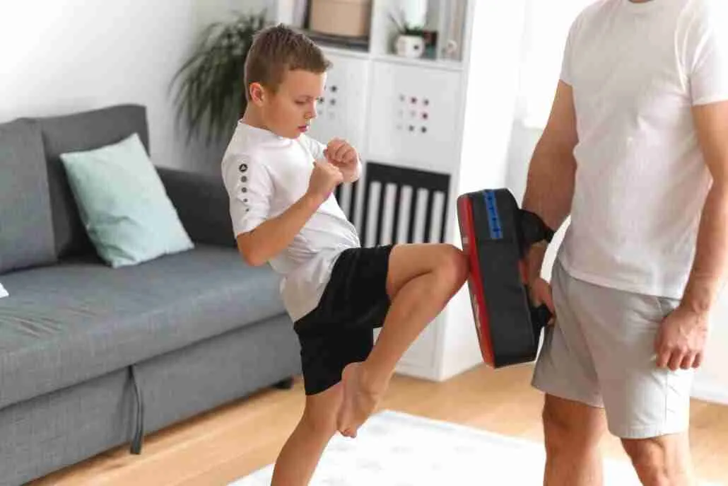 A young boy is training with father, martial arts, krav maga and brazillian jiu jitsu. Dad and son