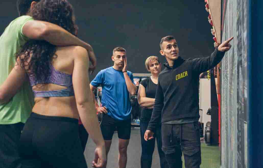 Coach Explaining Krav Maga Empowerment To Athletes In The Gym