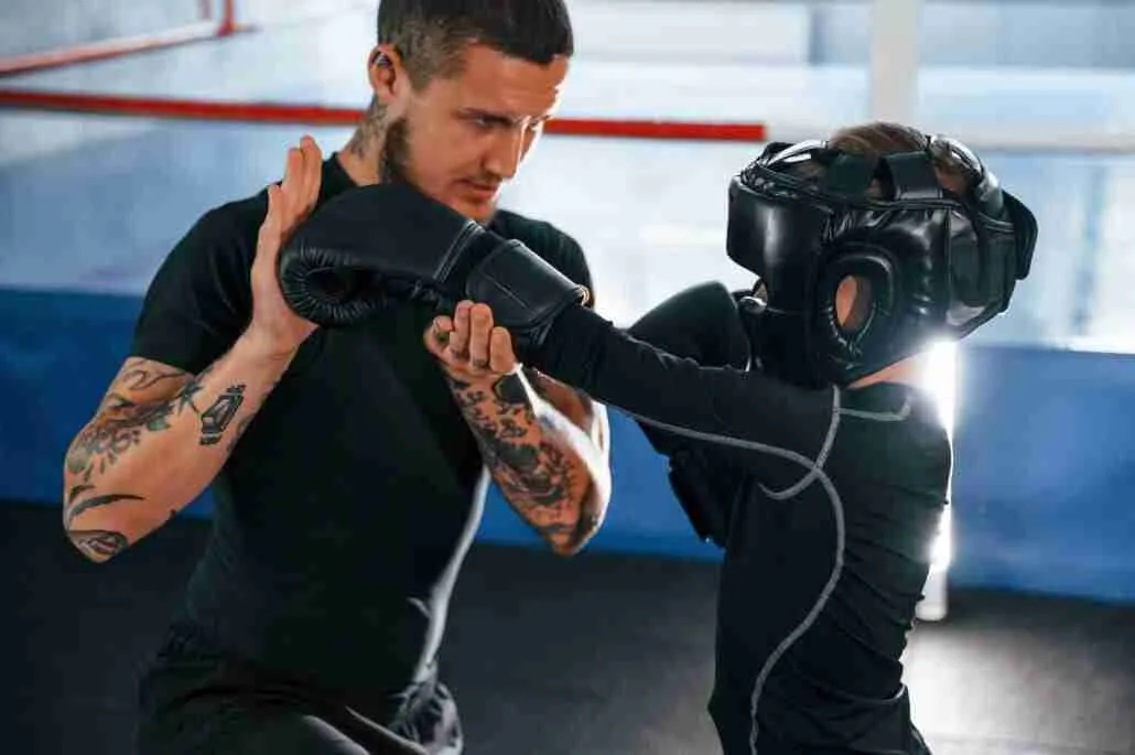 Coach Is Teaching The Boy Krav Maga Box Techniques Indoors