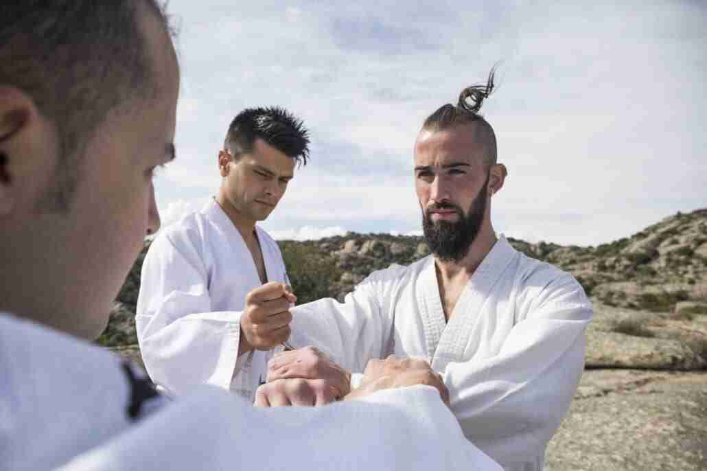 Men doing grip exercises during a martial arts training